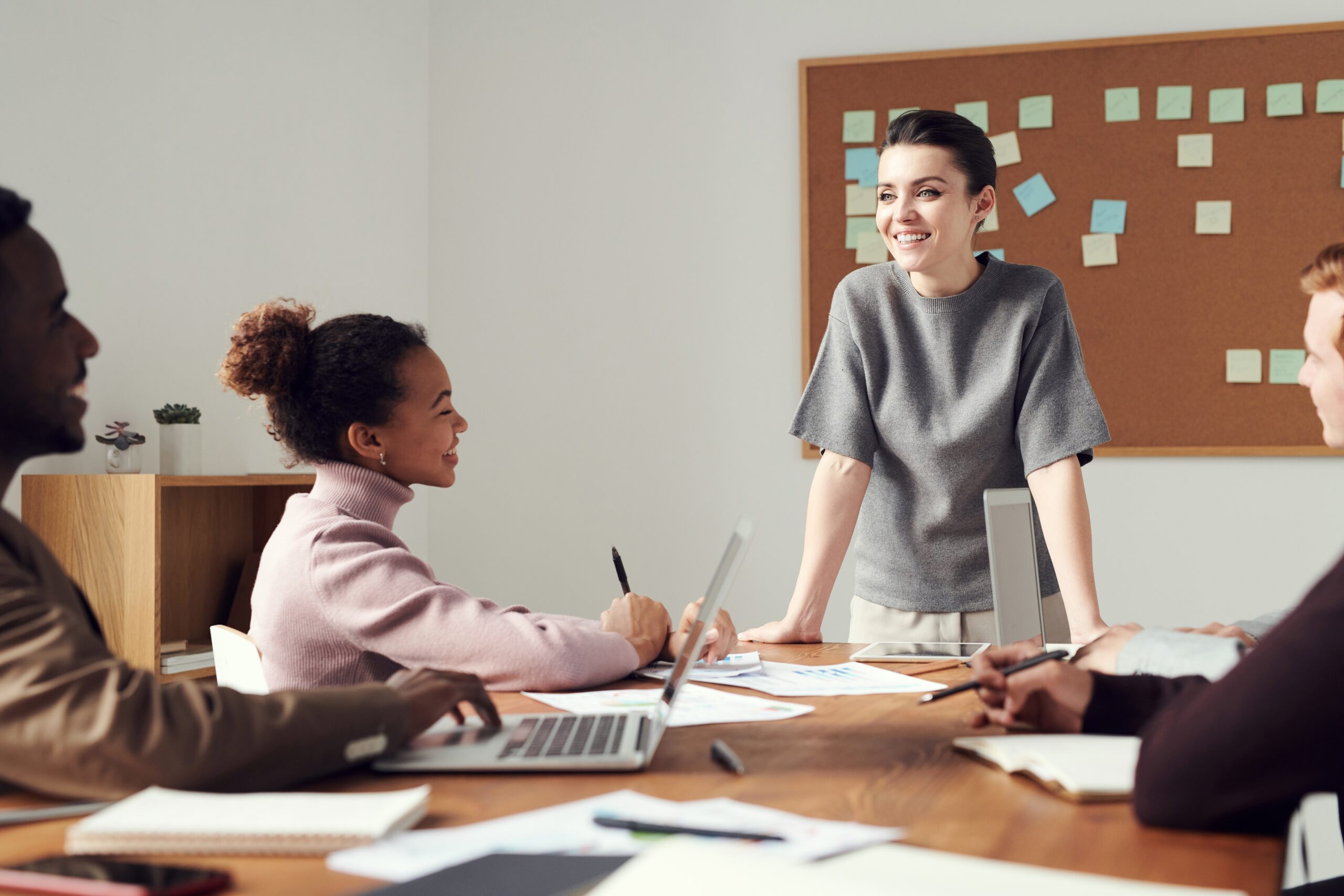 woman-wearing-gray-shirt-managing a team of employees, setting a good example for workplace well-being